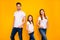 Photo of daddy mommy and little foxy lady holding hands in pockets wear casual outfit isolated yellow background