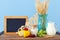 Photo of dairy products over old wooden table and pastel background. Symbols of jewish holiday - Shavuot