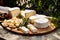 Photo of a delicious wooden plate with a variety of cheese and nuts