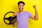 Photo of delighted funky person arm hold wheel raise fist success accomplishment isolated on yellow color background