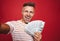 Photo of delighted man in striped t-shirt smiling and taking sel