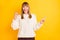 Photo of delighted person fist up indicate finger empty space wear knitted style sweater isolated on yellow color