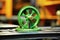 Photo of a detailed shot of a vibrant green wheel on a wooden table. Modern metal processing at an industrial enterprise.