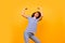 Photo of determined struggling girl arms hold look up empty space isolated on yellow color background