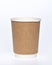 Photo of a disposable brown paper cup on a white background. Photo of a coffee cup made of recyclable materials. Empty paper