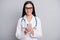 Photo of doctor lady hold telephone look screen wear stethoscope spectacles white uniform isolated grey color background