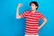 Photo of doubtful funny young man wear striped t-shirt measuring fingers small empty space isolated blue color