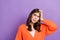 Photo of doubtful unsure uncertain lady orange cardigan looking empty space isolated violet color background