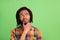 Photo of doubtful upset dark skin man wear plaid shirt arm chin looking empty space  green color background