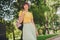 Photo of dreamy adorable young woman wear yellow t-shirt rucksack smiling walking outside city street