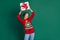 Photo of dreamy excited lady wear red sweater holding looing bow gift package empty space isolated green color