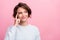 Photo of dreamy happy positive minded young woman look empty space finger temple isolated on pink color background