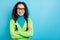 Photo of dreamy optimistic charming young woman look empty space wear glasses folded arms isolated on blue color