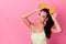 Photo of dreamy pretty woman wear yellow dress holding citrus halves head empty space isolated pink color background
