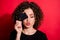 Photo of dreamy sweet curly woman wear casual black outfit closed eyes credit card lips pouted isolated red color