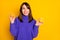 Photo of dreamy sweet young woman wear purple pullover holding citrus halves looking empty space isolated yellow color