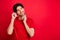 Photo of dreamy thoughtful guy look empty space think thoughts wear earphones red t-shirt isolated red color background