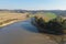 Photo of dry drained breeding pond with mud. Carps, perch, roach and other fish bodies on the shallow ground