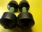 Photo of dumbbell hand muscle exercise equipment with a yellow background