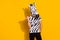 Photo of eccentric funky man wear zebra print t-shirt mask pointing thumb finger empty space isolated yellow color