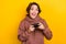 Photo of ecstatic overjoyed woman with short hairdo wear brown hoodie hold playstation joystick  on yellow color