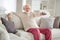 Photo of elderly man happy positive smile sit sofa house have fun watch television switch channel remote controller