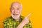 Photo of elderly man happy smile indicate finger empty space advert promo recommend advise isolated over yellow color