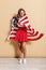 Photo of elegant young woman wearing american flag standing and smiling