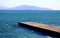 Photo of the endless blue sea with a pier