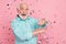 Photo of energetic middle aged man dance fall confetti enjoy discotheque isolated over pastel color background