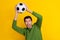 Photo of excited cheerful guy dressed green pullover catching football ball isolated yellow color background