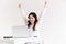 Photo of excited chinese businesswoman with long dark hair screaming with raised arms and celebrating success while working in
