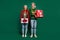 Photo of excited dream couple hold pile gifts enjoy party x-mas wear ugly sweater isolated green color background