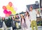 Photo of excited family daddy mommy child surprised happy smile wear party hat celebrate girl hold air balloons look