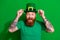 Photo of excited funny guy dressed t-shirt arms cap celebrating clover day isolated green color background