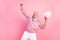 Photo of excited grey hair aged man dance wear eyewear cap sweater isolated on pink background