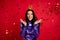 Photo of excited happy lady wear crown purple sequins dress fall confetti celebrate  on red color background