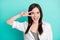 Photo of excited happy nice young woman make v-sign hello cheerful mood isolated on teal color background