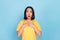 Photo of excited impressed gorgeous girl with bob hairstyle wear yellow t-shirt look empty space sale isolated on blue