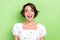 Photo of excited impressed woman dressed white top smiling open mouth isolated green color background