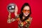 Photo of excited pretty woman wear flower print dress eyewear holding disco ball isolated red color background