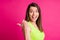 Photo of excited shocked lady indicate thumb empty space open mouth crazy wear green top isolated bright pink color