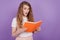 Photo of excited speechless lady read book open mouth wear casual outfit on purple background