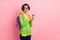 Photo of excited woman wear green cardigan spectacles rucksack holding modern gadget empty space isolated pink color