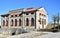 Photo of the facade facing west and the side facing south, of the Bovolenta water pump, illuminated by the sun of a winter afterno