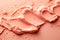 a photo featuring cosmetic smears of creamy texture on a peach - colored background