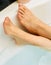 Photo of female feet closeup in bathtub