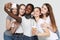 Photo of five multiethnic girls laughing and taking selfie