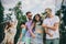 Photo of five positive friends dancing chilling hanging out forest festival party outdoors