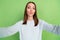 Photo of flirty millennial brunette lady blow kiss wear blue jumper isolated on green color background